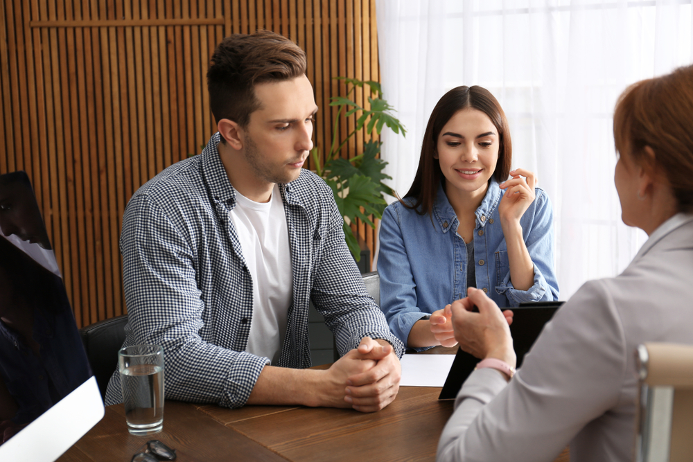 man and woman discussing a divorce with lawyer